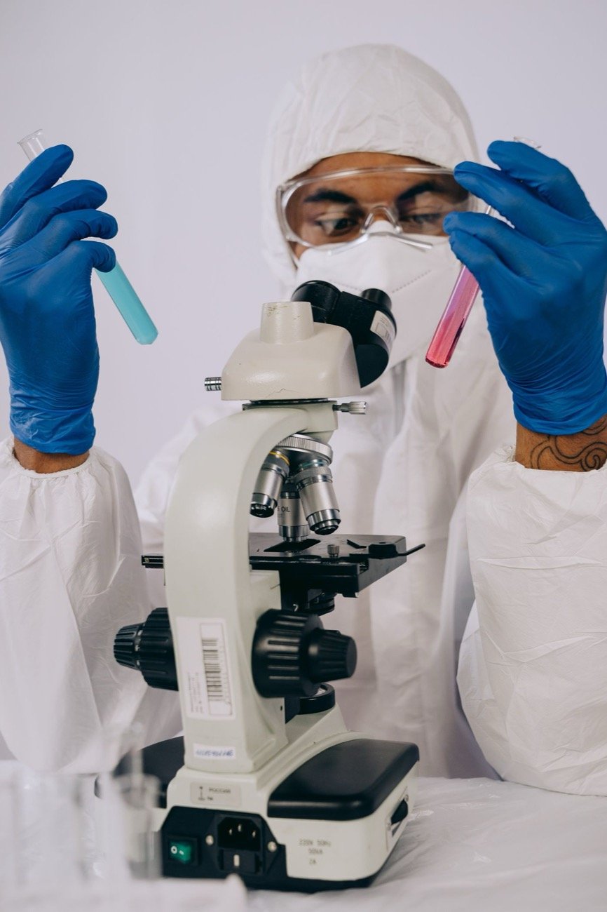 Researcher examining a vial in a laboratory
