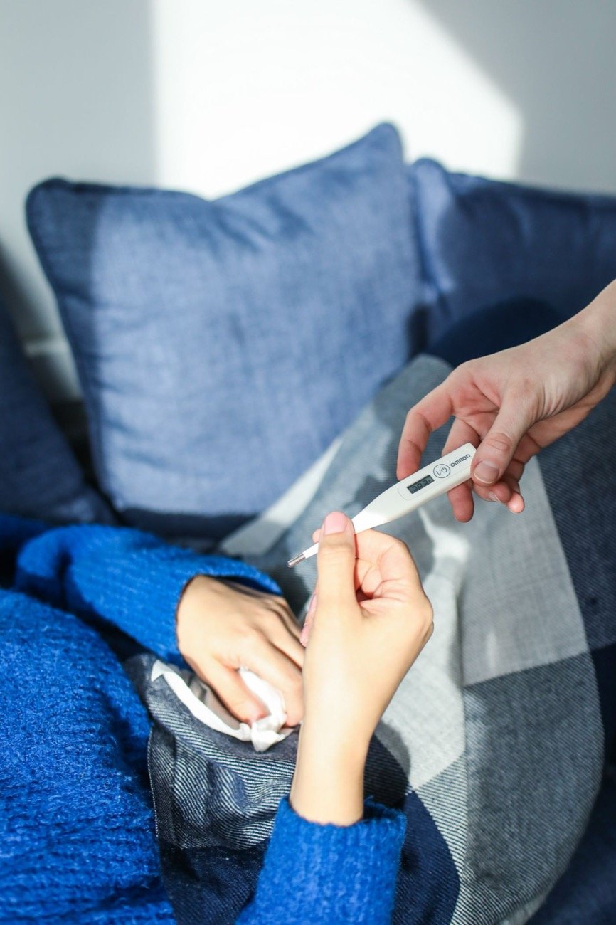 Person resting at home with cold symptoms