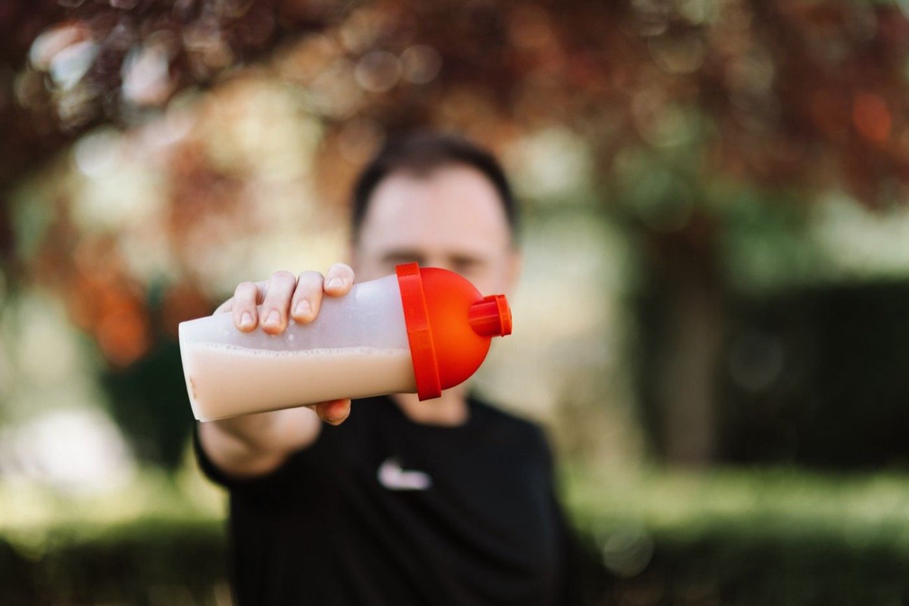 Person holding a drink in a shaker tumbler
